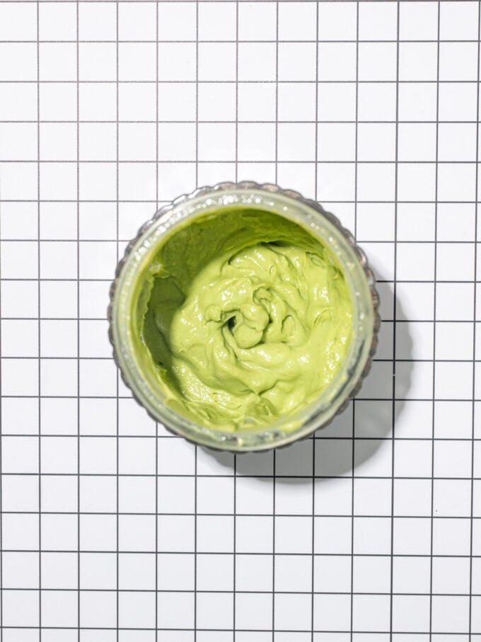 blender jar of creamy avocado dressing seen from overhead